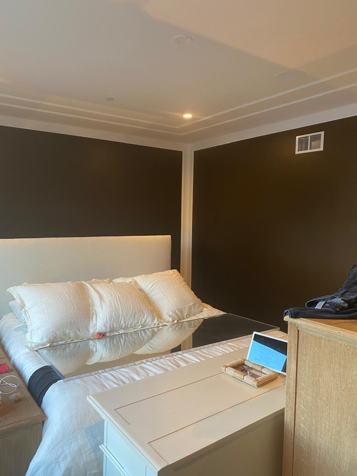 Bedroom with dark walls and white trim