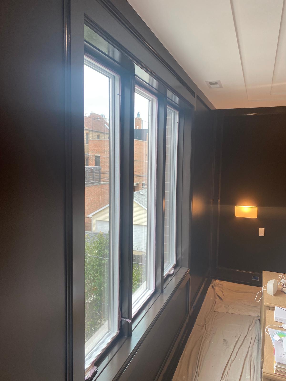 Bedroom with dark painted trim around windows